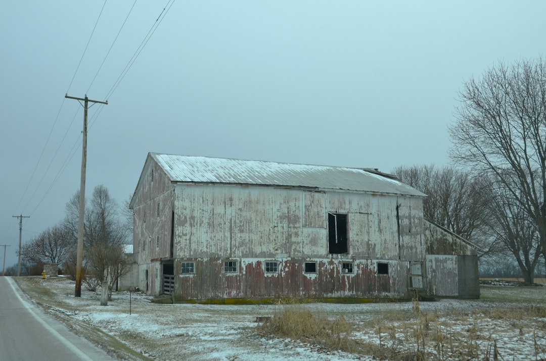 A 'For Sale' sign in front of a house.